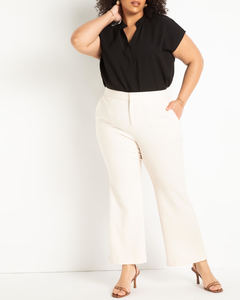 Front of a model wearing a size 26 The 365 Suit Crop Flare Leg Trouser in White Swan by ELOQUII. | dia_product_style_image_id:272933